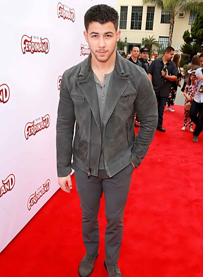 Nick Jonas Posing with gey Leather Jacket