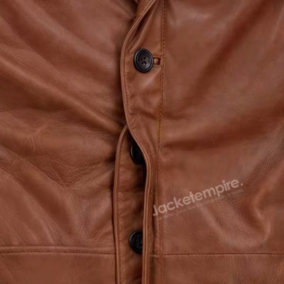 Detailed view of brown leather blazer front closure with black buttons